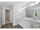Bathroom with double vanity, quartz countertop, and tile surround shower with a glass door at 5103 Heathland Dr # 50, Charlotte, NC 28215