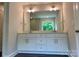 Bathroom with double vanity, ample counter space, and modern lighting fixtures at 5103 Heathland Dr # 50, Charlotte, NC 28215