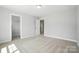Spacious bedroom with neutral carpet, a walk-in closet, and views into other rooms at 5103 Heathland Dr # 50, Charlotte, NC 28215