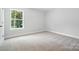 Cozy bedroom featuring a serene window view and plush carpeting for comfort at 5103 Heathland Dr # 50, Charlotte, NC 28215
