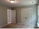 Neutral bedroom with carpet floors, closet, and base trim at 5103 Heathland Dr # 50, Charlotte, NC 28215