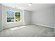 Sunlit bedroom with large window showing neighborhood view and plush carpet at 5103 Heathland Dr # 50, Charlotte, NC 28215