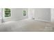 Spacious bedroom featuring plush carpeting, ample natural light, and white trim at 5103 Heathland Dr # 50, Charlotte, NC 28215