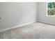 Bright bedroom with a large window and neutral carpeting, perfect for relaxation at 5103 Heathland Dr # 50, Charlotte, NC 28215
