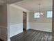 Elegant dining room with wood floors, wainscoting, and a stylish chandelier at 5103 Heathland Dr # 50, Charlotte, NC 28215