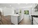 Open concept kitchen with a large island, stainless steel appliances, and seamless flow to the living area at 5103 Heathland Dr # 50, Charlotte, NC 28215