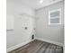 Bright laundry room with overhead shelving, ample electric outlets, and sleek flooring at 5103 Heathland Dr # 50, Charlotte, NC 28215