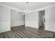 Spacious living room featuring hardwood floors, neutral walls, and a large window at 5103 Heathland Dr # 50, Charlotte, NC 28215