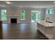 Bright living room featuring hardwood floors, a fireplace, and access to the outdoor patio at 5103 Heathland Dr # 50, Charlotte, NC 28215