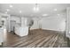 Open-concept living room with hardwood floors that seamlessly connects to the kitchen and staircase at 5103 Heathland Dr # 50, Charlotte, NC 28215