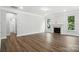 Large living room featuring hardwood floors, a fireplace, and a view of the bathroom at 5103 Heathland Dr # 50, Charlotte, NC 28215