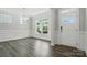 Living room with gray flooring, white walls, with crown moulding, and a front door at 5103 Heathland Dr # 50, Charlotte, NC 28215