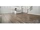 Open-concept living room with a kitchen island, hardwood floors, and stainless steel appliances at 5103 Heathland Dr # 50, Charlotte, NC 28215