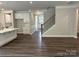 Spacious open-concept living area featuring hardwood floors, and white cabinets at 5103 Heathland Dr # 50, Charlotte, NC 28215