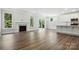 Spacious living room with a fireplace, hardwood floors, and views of the backyard at 5103 Heathland Dr # 50, Charlotte, NC 28215