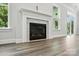 Close-up of modern fireplace with marble surround and hardwood floors at 5103 Heathland Dr # 50, Charlotte, NC 28215