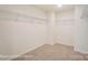 Spacious walk-in closet featuring neutral carpet and wire shelving to maximize organization at 5103 Heathland Dr # 50, Charlotte, NC 28215