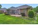 Brick house with landscaped backyard featuring a screened-in porch and patio, perfect for outdoor entertaining at 534 Ballymote Ct, Matthews, NC 28104