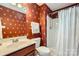 Full bathroom featuring shower, red floral wallpaper, sink, and toilet at 534 Ballymote Ct, Matthews, NC 28104