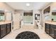 Primary bathroom featuring a tub, shower, double vanities, and tiled flooring at 534 Ballymote Ct, Matthews, NC 28104