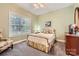 Comfortable bedroom with carpet, and large window showing tree line at 534 Ballymote Ct, Matthews, NC 28104
