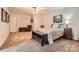 A well-lit bedroom featuring a ceiling fan, neutral walls, and a patterned comforter, creating a serene atmosphere at 534 Ballymote Ct, Matthews, NC 28104