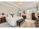 Spacious bedroom with tray ceiling, carpet, and a view of the hallway at 534 Ballymote Ct, Matthews, NC 28104