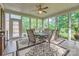 Bright sunroom with large windows, a ceiling fan, and a table with seating, ideal for relaxation and gatherings at 534 Ballymote Ct, Matthews, NC 28104