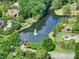 An aerial view shows a neighborhood pond with a fountain and pool at 6004 Quintessa Dr, Matthews, NC 28104