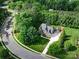 An aerial view showcases the lush landscaping and the house on a cul-de-sac at 6004 Quintessa Dr, Matthews, NC 28104