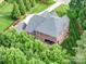 Aerial view of the rear of the brick home with a covered outdoor patio at 6004 Quintessa Dr, Matthews, NC 28104