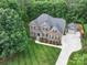 Aerial view of a home featuring a detached garage and basketball court at 6004 Quintessa Dr, Matthews, NC 28104