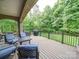 A large back deck has outdoor seating overlooking the lawn at 6004 Quintessa Dr, Matthews, NC 28104