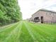 Large backyard with neatly maintained lawn and mature trees at 6004 Quintessa Dr, Matthews, NC 28104
