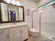 Modern bathroom with a glass-enclosed shower, granite countertop vanity, and stylish tile flooring at 6004 Quintessa Dr, Matthews, NC 28104