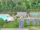 Aerial view of a neighborhood clubhouse, tennis court, and pool with a manicured lawn at 6004 Quintessa Dr, Matthews, NC 28104