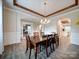 Elegant dining room featuring wood table and designer lighting at 6004 Quintessa Dr, Matthews, NC 28104