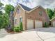 Charming brick home with a two-car garage and manicured landscaping at 6004 Quintessa Dr, Matthews, NC 28104