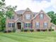 Charming two-story brick home with blue shutters and stone front entrance at 6004 Quintessa Dr, Matthews, NC 28104