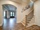 Welcoming foyer featuring hardwood floors, an arched entryway, and a staircase with decorative railings at 6004 Quintessa Dr, Matthews, NC 28104