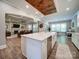 Open-concept kitchen with island, stainless steel appliances, and view of living room at 6004 Quintessa Dr, Matthews, NC 28104