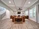 Spacious living room features coffered ceilings, a cozy fireplace, and lots of natural light from large windows at 6004 Quintessa Dr, Matthews, NC 28104