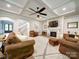 Inviting living room with a stone fireplace, ceiling fan, and large area rug on wood flooring at 6004 Quintessa Dr, Matthews, NC 28104