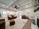 Open concept living area featuring coffered ceilings, a ceiling fan, and hardwood floors leading to the kitchen at 6004 Quintessa Dr, Matthews, NC 28104