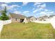 Large, grassy backyard featuring a white picket fence, perfect for outdoor activities and relaxation at 7113 Meridale Forest Dr, Charlotte, NC 28269