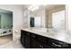 Bathroom features a double sink vanity with black cabinets and framed mirror at 7113 Meridale Forest Dr, Charlotte, NC 28269