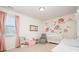 This Bedroom features pink curtains, flower wallpaper, and a crib at 7113 Meridale Forest Dr, Charlotte, NC 28269