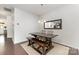 Dining room with a wooden table, bench, seating for four, and a modern light fixture at 7113 Meridale Forest Dr, Charlotte, NC 28269