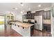 Spacious kitchen featuring a large island with granite countertops and stainless steel appliances at 7113 Meridale Forest Dr, Charlotte, NC 28269