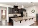 Beautiful kitchen with black cabinets, stainless steel appliances, and a large center island at 7113 Meridale Forest Dr, Charlotte, NC 28269